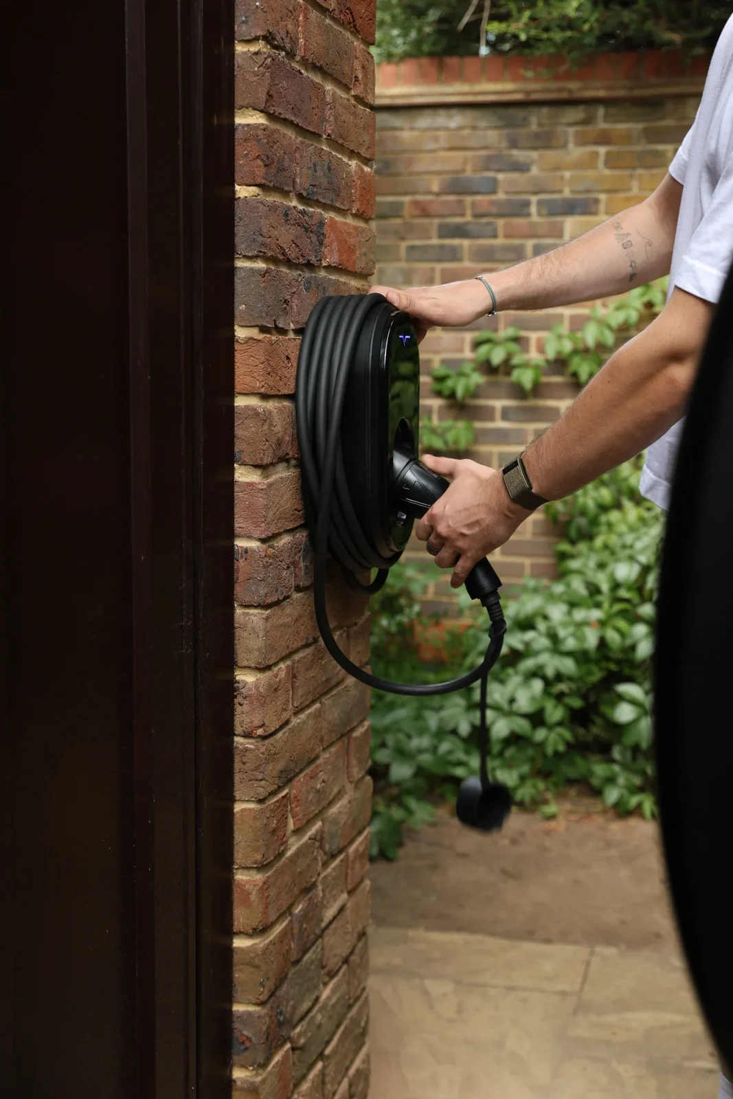 Seven Pro installed on a brick wall with its cable ready to use