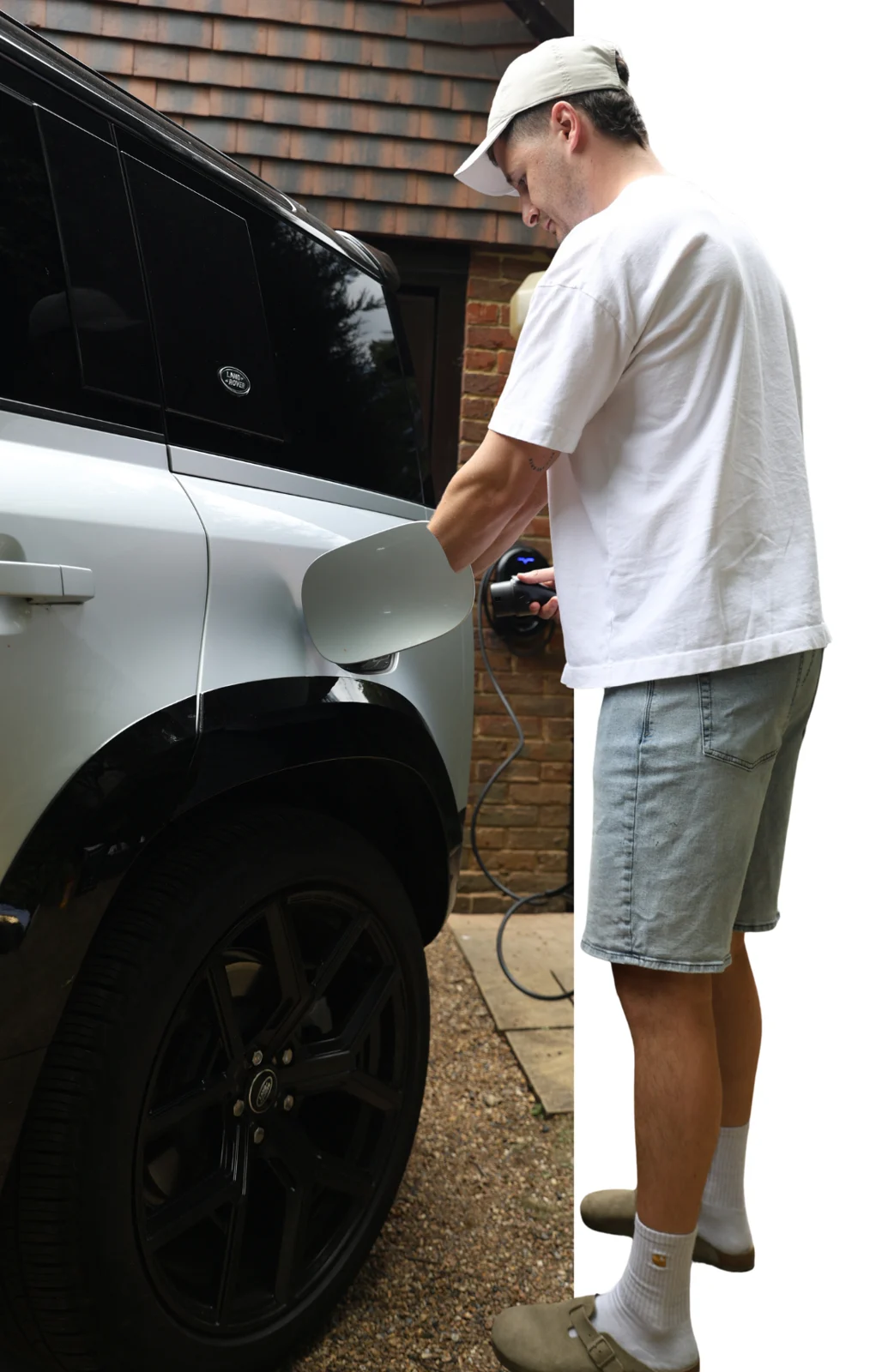 Driver plugging in an electric car at home
